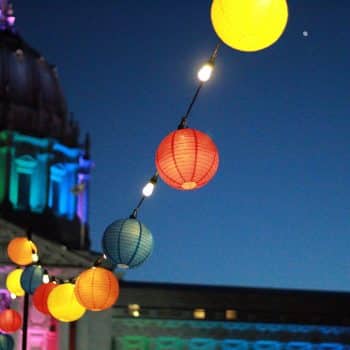 Brightly coloured lanterns outside city hall during Pride